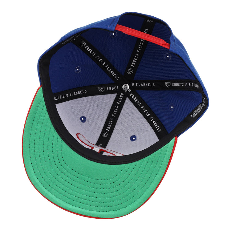 The Tulsa Drillers EFF MiLB Vintage Snapback by Ebbets Field Flannels is shown inside-out, displaying a green brim with red edge, black sweatband, and black inner panels featuring the “Ebbets Field Flannels” label in white.