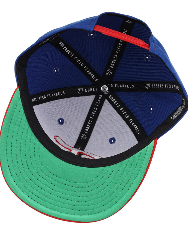 The Tulsa Drillers EFF MiLB Vintage Snapback by Ebbets Field Flannels is shown inside-out, displaying a green brim with red edge, black sweatband, and black inner panels featuring the “Ebbets Field Flannels” label in white.