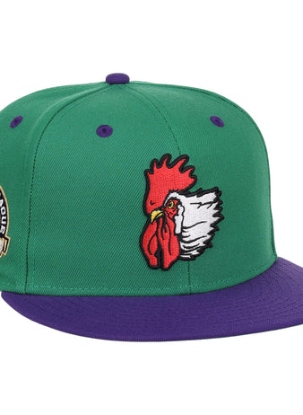 The Port City Roosters EFF MiLB Vintage Snapback by Ebbets Field Flannels is a green cap with a purple brim, featuring an embroidered rooster head and a Southern League patch, inspired by vintage minor league style.