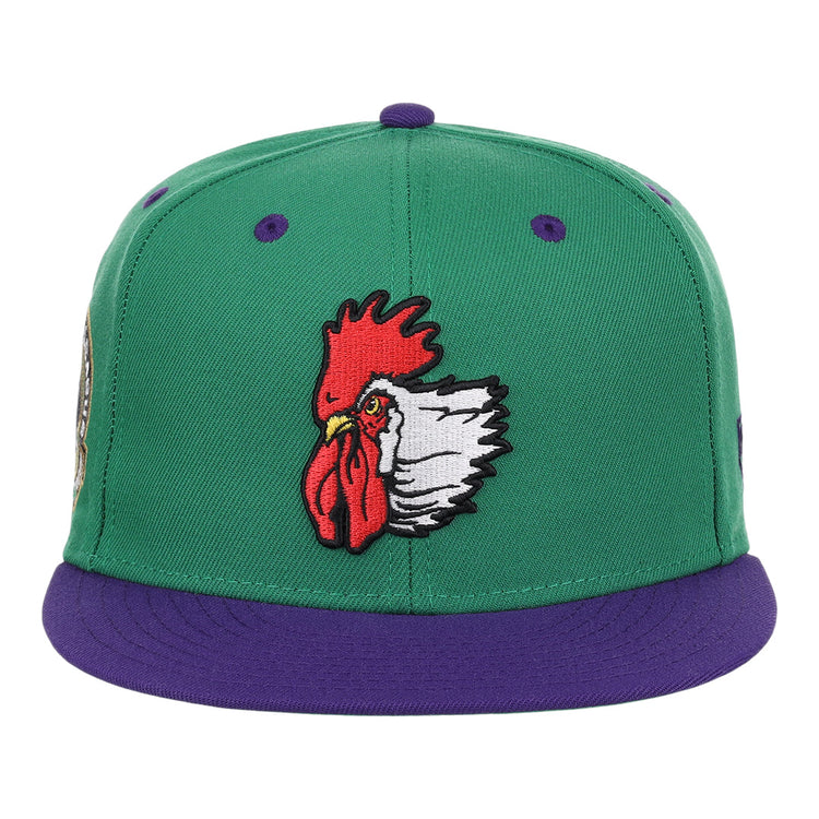 The Port City Roosters EFF MiLB Vintage Snapback by Ebbets Field Flannels features a green cap, purple brim, and an embroidered red and white rooster head—ideal for fans of vintage Minor League or Port City Roosters memorabilia.