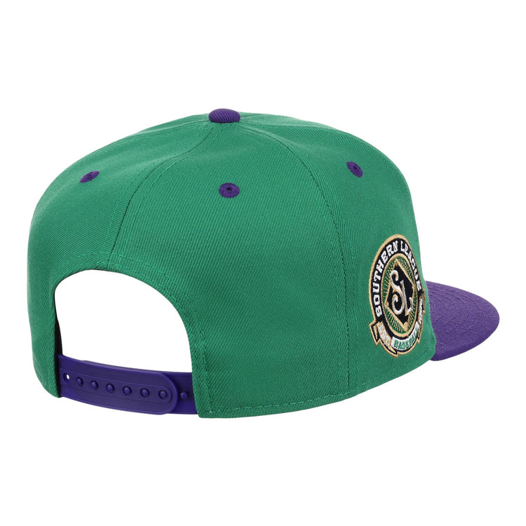 The Ebbets Field Flannels Port City Roosters EFF MiLB Vintage Snapback features green and purple panels, a round Southern Lids patch, and an adjustable purple strap—evoking classic Minor League style.
