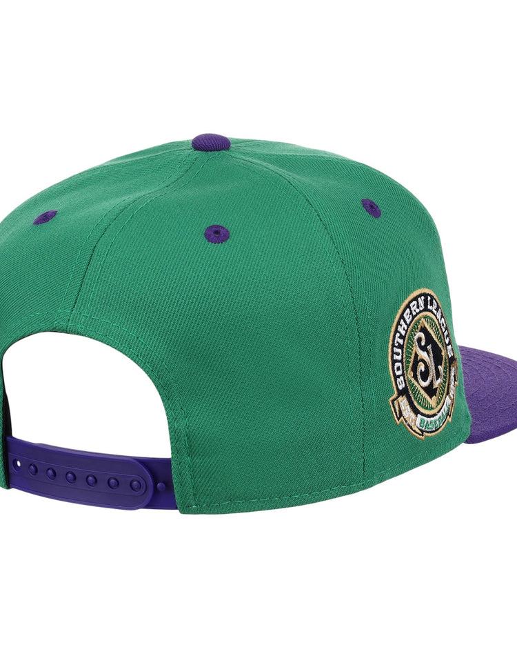 The Ebbets Field Flannels Port City Roosters EFF MiLB Vintage Snapback features green and purple panels, a round Southern Lids patch, and an adjustable purple strap—evoking classic Minor League style.