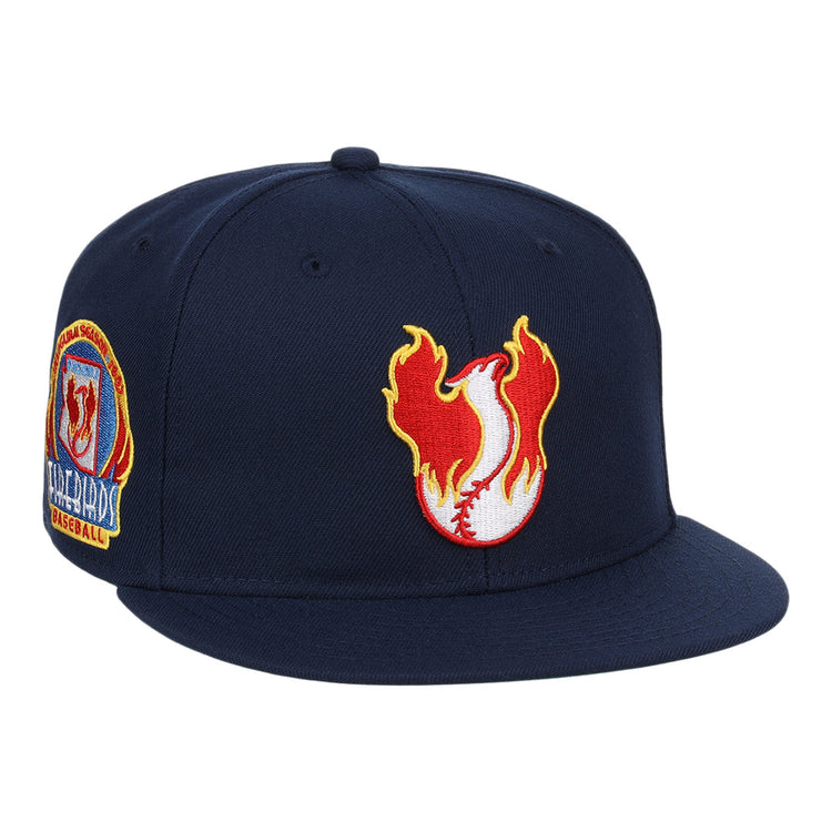 The Phoenix Firebirds EFF MiLB Vintage Snapback by Ebbets Field Flannels is a navy snapback with a flaming baseball logo up front and a colorful embroidered Phoenix Firebirds patch on the side, inspired by vintage Pacific Coast League style.