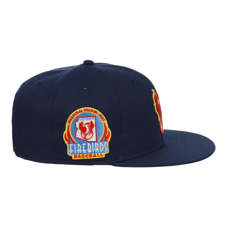 The Phoenix Firebirds EFF MiLB Vintage Snapback by Ebbets Field Flannels is a navy cap with red, yellow, and blue embroidery and a colorful side patch, part of the Vintage Minor League collection.
