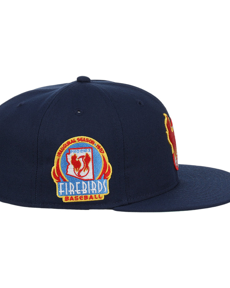 The Phoenix Firebirds EFF MiLB Vintage Snapback by Ebbets Field Flannels is a navy cap with red, yellow, and blue embroidery and a colorful side patch, part of the Vintage Minor League collection.