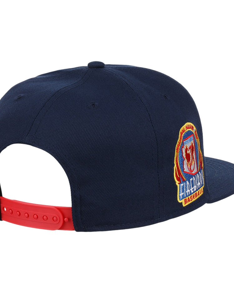 The Ebbets Field Flannels Phoenix Firebirds EFF MiLB Vintage Snapback is a navy cap with a red adjustable strap, featuring a colorful embroidered FIREMAN patch on the side for classic Minor League style.