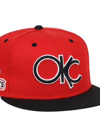 The Oklahoma City 89ers EFF MiLB Vintage Snapback by Ebbets Field Flannels is a red and black adjustable hat with a large OKC logo front and an 89ers side patch, from our Vintage Minor League collection.