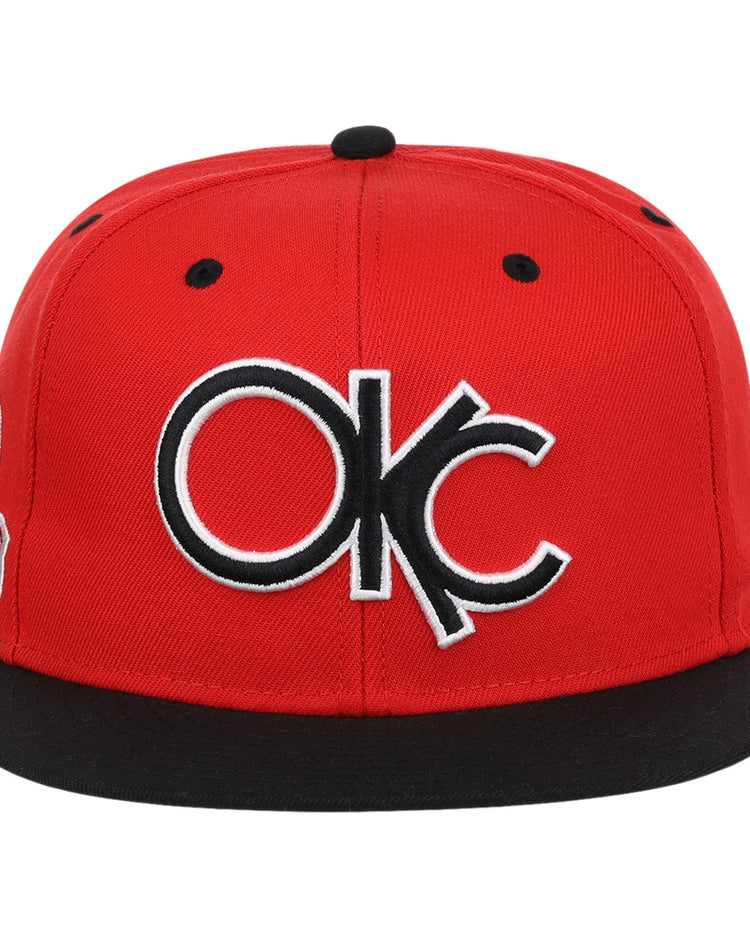 The Ebbets Field Flannels Oklahoma City 89ers EFF MiLB Vintage Snapback features a red cap, black brim, bold white and black OKC embroidery on the front, and an adjustable snapback closure.