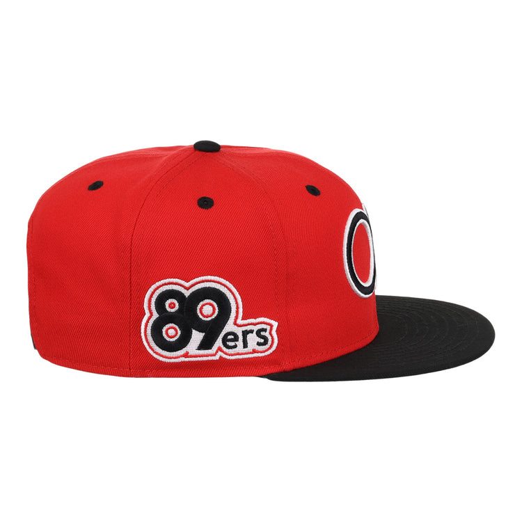 The Oklahoma City 89ers EFF MiLB Vintage Snapback by Ebbets Field Flannels is a red hat with a black flat brim, 89ers embroidery in black, white, and red on the side, a circular front logo, and an adjustable snapback closure.
