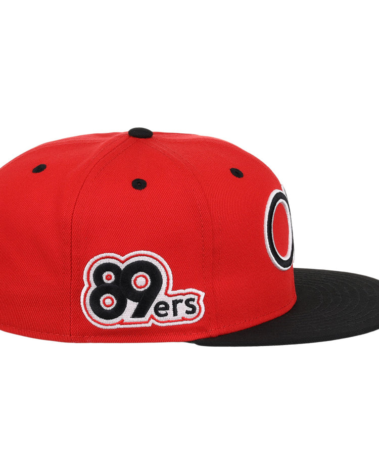 The Oklahoma City 89ers EFF MiLB Vintage Snapback by Ebbets Field Flannels is a red hat with a black flat brim, 89ers embroidery in black, white, and red on the side, a circular front logo, and an adjustable snapback closure.