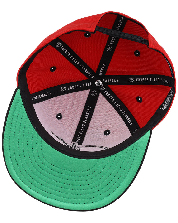 The Oklahoma City 89ers EFF MiLB Vintage Snapback by Ebbets Field Flannels is a red hat with black lining featuring brand text, metal ventilation holes, a green underbrim, and an adjustable snapback closure, viewed from the inside.