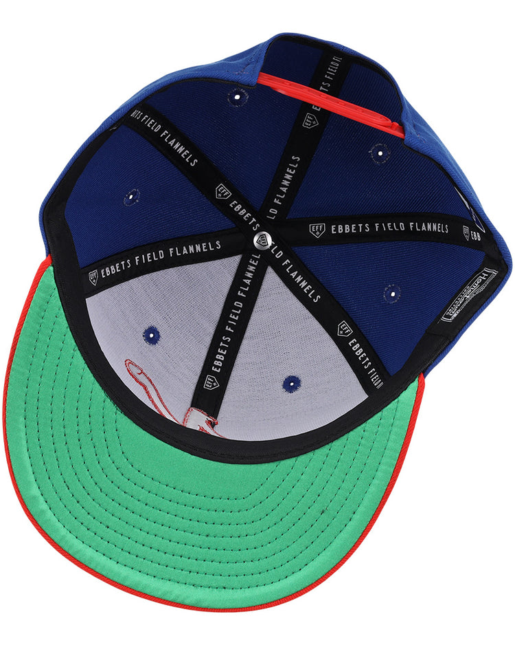 The Nashville Sounds EFF MiLB Vintage Snapback by Ebbets Field Flannels features a blue exterior, green underside brim, red trim, black bands labeled EBBETS FIELD FLANNELS, and is part of the Vintage Minor League collection.