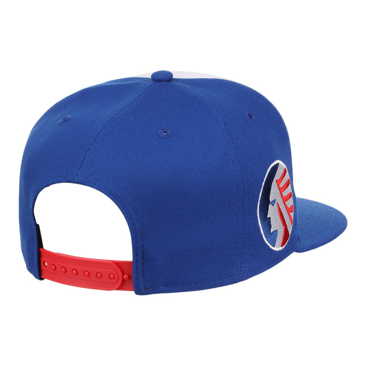 The Ebbets Field Flannels Memphis Chicks EFF MiLB Vintage Snapback features a blue adjustable cap with a red strap and round patch with blue and red details, displayed from the rear side.