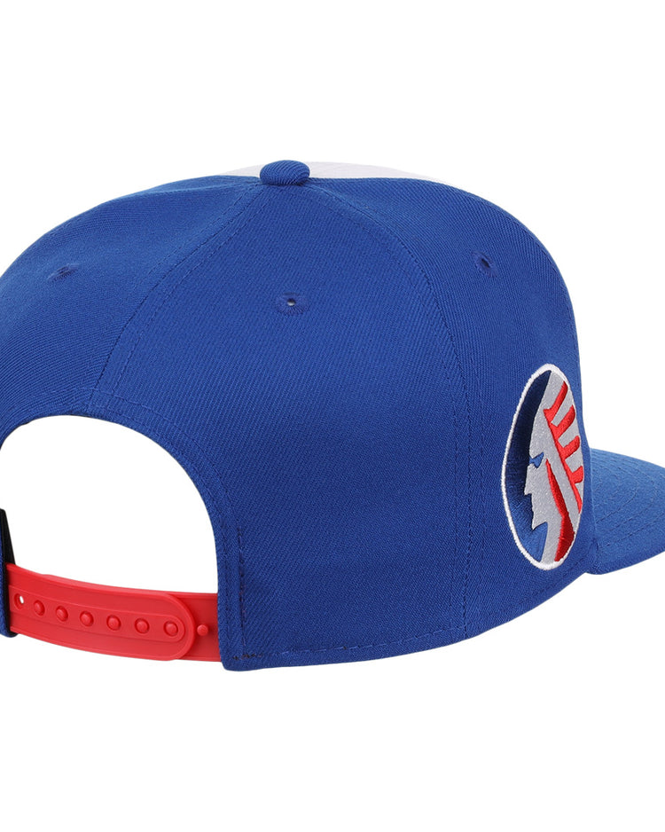 The Ebbets Field Flannels Memphis Chicks EFF MiLB Vintage Snapback features a blue adjustable cap with a red strap and round patch with blue and red details, displayed from the rear side.