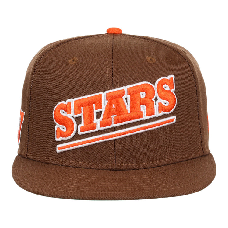 The Las Vegas Stars EFF MiLB Vintage Snapback by Ebbets Field Flannels is a brown cap with STARS boldly embroidered in orange and white diagonally, featuring an orange top button and snapback closure.