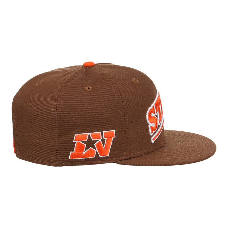 The Ebbets Field Flannels Las Vegas Stars EFF MiLB Vintage Snapback is a brown flat-brim adjustable cap with orange and white embroidered LV and star patches, plus partial front text, evoking a classic Minor League Las Vegas Stars style.