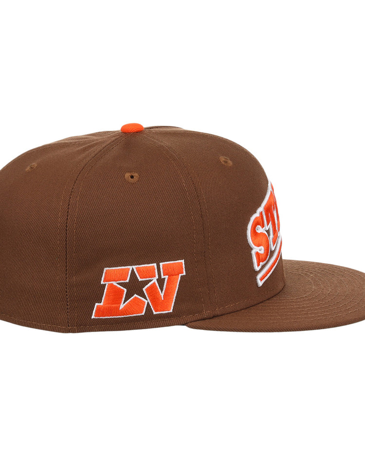 The Ebbets Field Flannels Las Vegas Stars EFF MiLB Vintage Snapback is a brown flat-brim adjustable cap with orange and white embroidered LV and star patches, plus partial front text, evoking a classic Minor League Las Vegas Stars style.