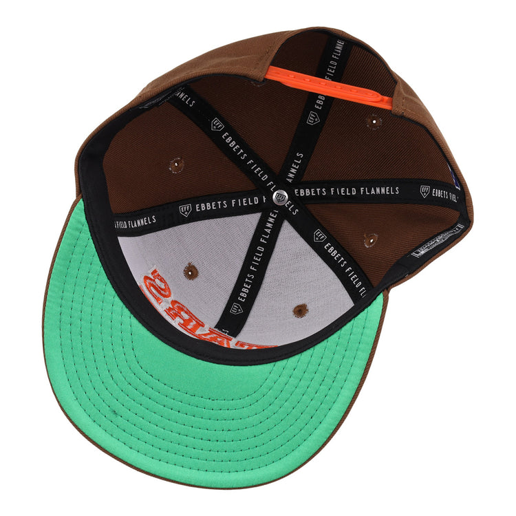 The Las Vegas Stars EFF MiLB Vintage Snapback by Ebbets Field Flannels features a brown exterior, black branded taping inside, a green underbrim, and an orange snapback strap—ideal for fans of vintage minor league style.