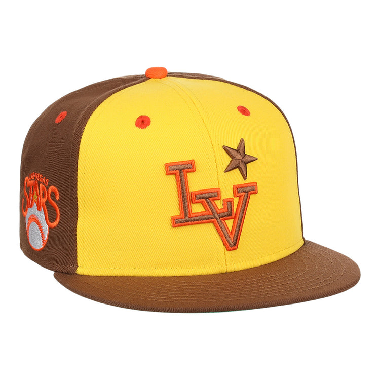 The Ebbets Field Flannels Las Vegas Stars EFF MiLB Vintage Snapback in yellow features a brown brim, orange LV logo, brown star on the front, and an embroidered “Las Vegas Stars” Minor League Baseball logo on the side.