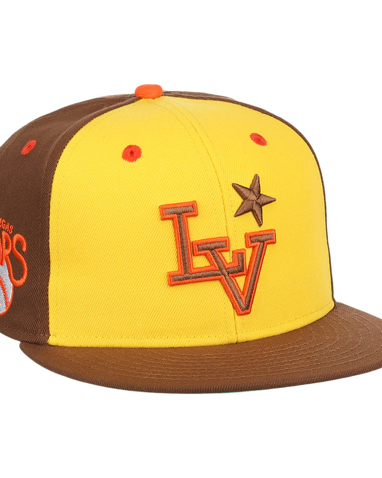 The Ebbets Field Flannels Las Vegas Stars EFF MiLB Vintage Snapback in yellow features a brown brim, orange LV logo, brown star on the front, and an embroidered “Las Vegas Stars” Minor League Baseball logo on the side.