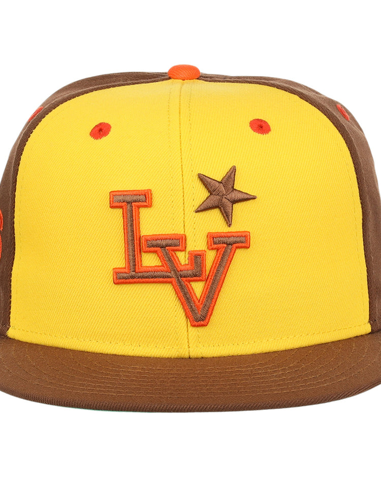 The Ebbets Field Flannels Las Vegas Stars EFF MiLB Vintage Snapback in yellow features brown brim and side panels, an orange LV logo, a brown star on the front, and an orange top button, inspired by the Vintage Minor League team.