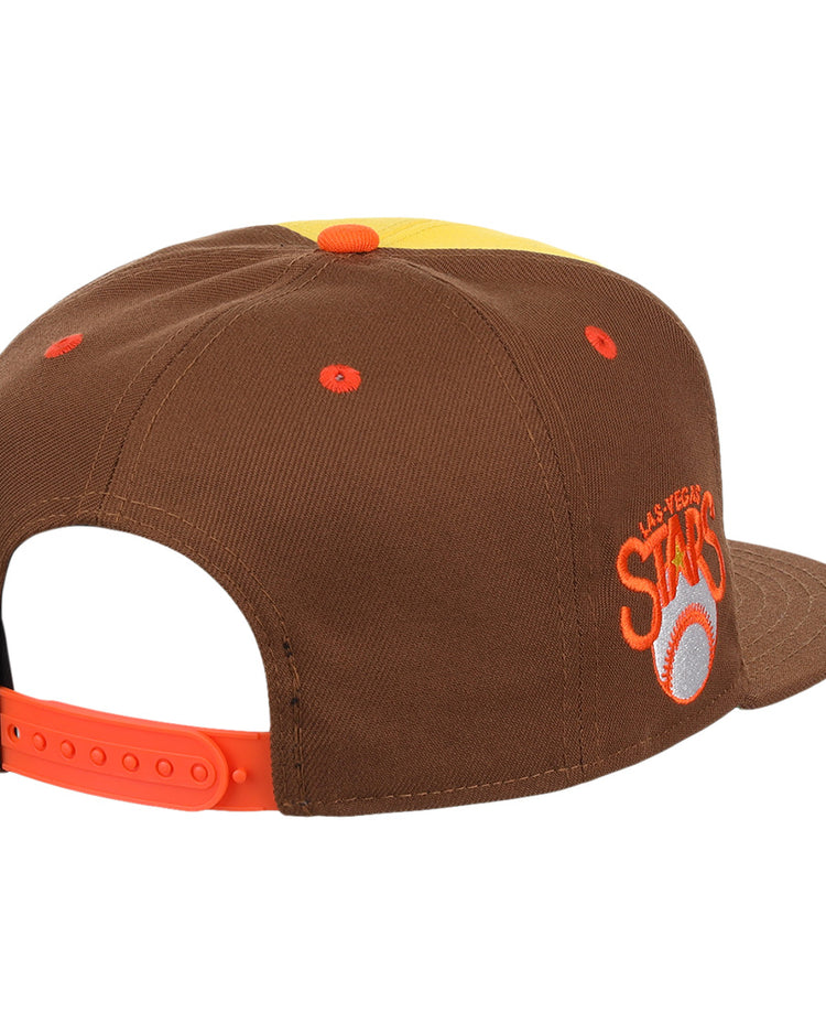 The Ebbets Field Flannels Las Vegas Stars EFF MiLB Vintage Snapback features a yellow cap with brown panels, orange strap and eyelets, embroidered ASTROS logo, white baseball with orange star on the side, and a vintage Minor League style.