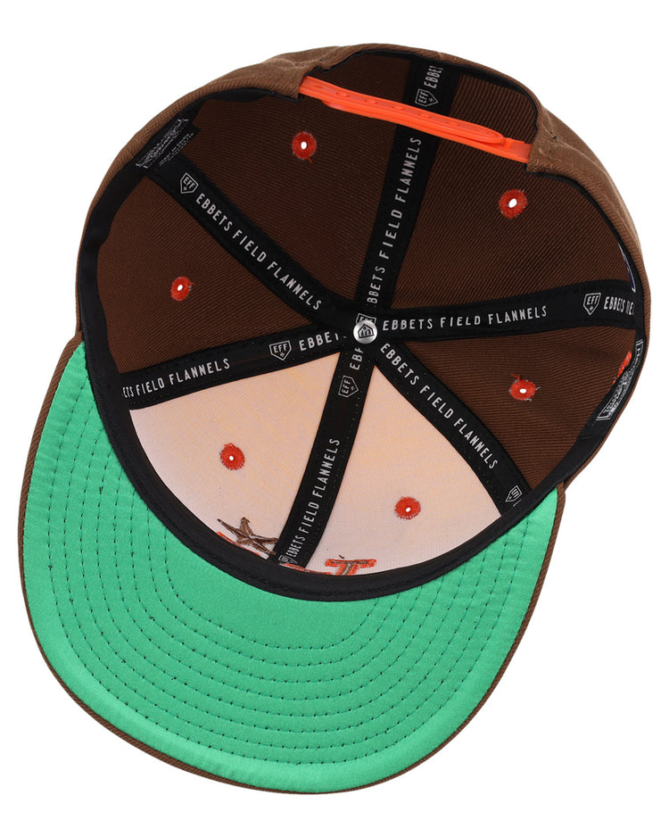 The Las Vegas Stars EFF MiLB Vintage Snapback by Ebbets Field Flannels features a yellow design, adjustable fit, orange eyelets, green underside brim, branded black interior strips, and a printed cowboy and horse scene.