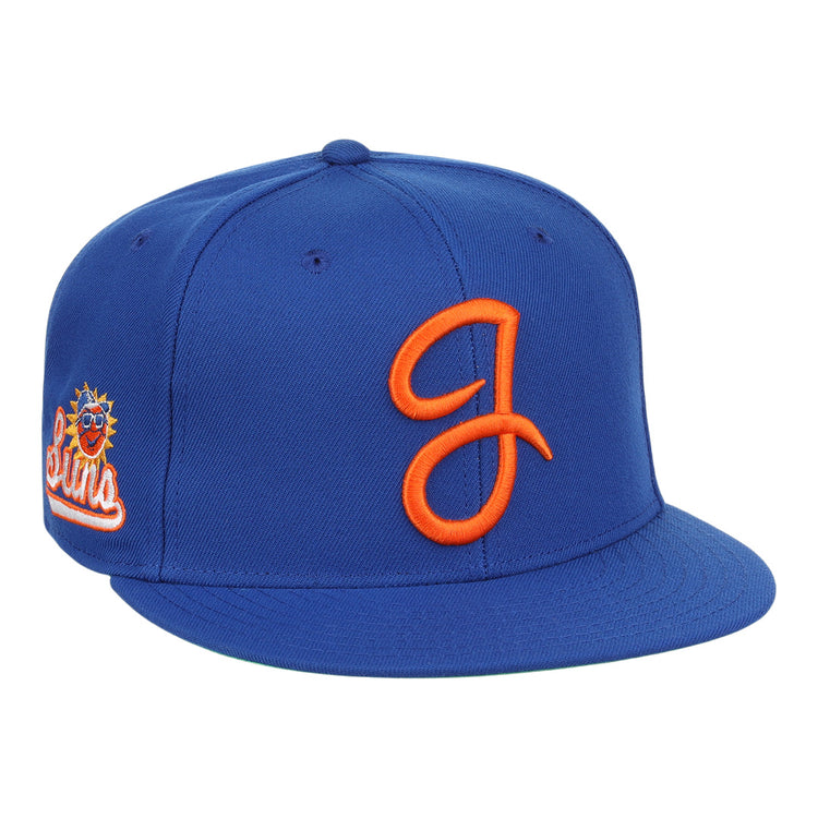 The Jacksonville Suns EFF MiLB Vintage Snapback by Ebbets Field Flannels is a royal blue adjustable cap featuring an orange embroidered J logo on the front and a sun logo with Suns on the side, inspired by vintage Minor League style.
