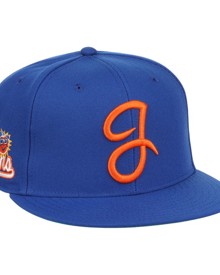 The Jacksonville Suns EFF MiLB Vintage Snapback by Ebbets Field Flannels is a royal blue adjustable cap featuring an orange embroidered J logo on the front and a sun logo with Suns on the side, inspired by vintage Minor League style.