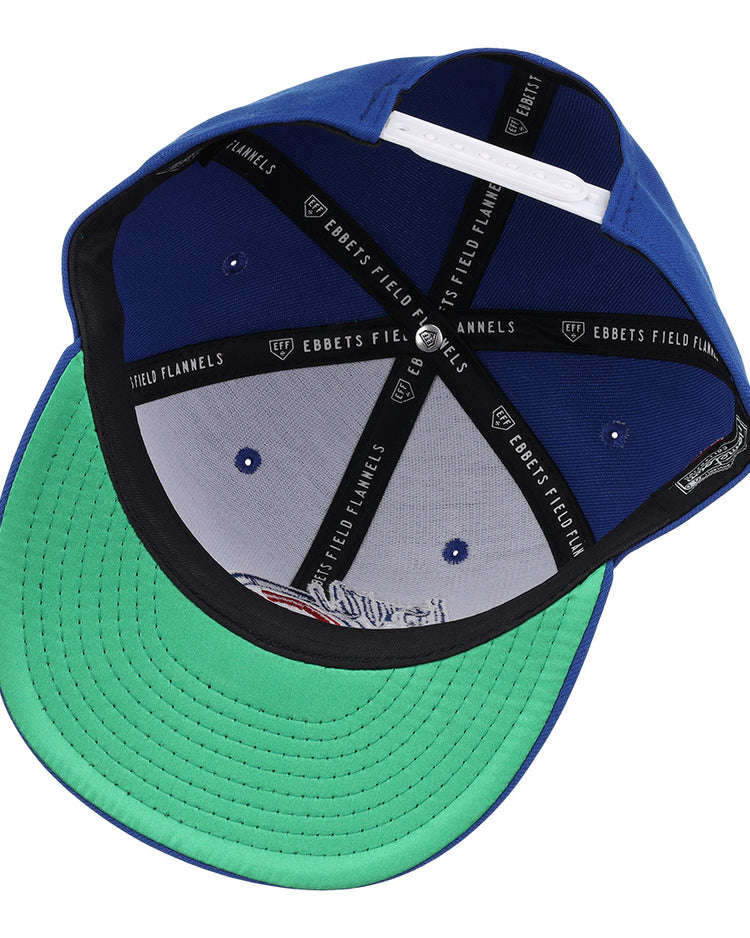 The Iowa Cubs EFF MiLB Vintage Snapback by Ebbets Field Flannels features a blue crown, green brim seen from underneath, black inner band with EBBETS FIELD FLANNELS branding, and a white adjustable snapback strap at the back.