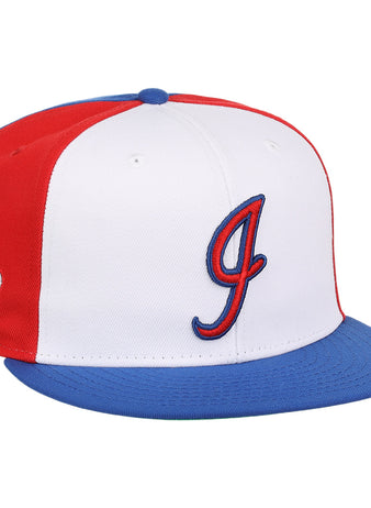 The Ebbets Field Flannels Indianapolis Indians EFF MiLB Vintage Snapback features a white front, red sides, blue brim and button, a stylized red and blue J on the front, and a cartoon baseball character from the Vintage Minor League collection on the side.