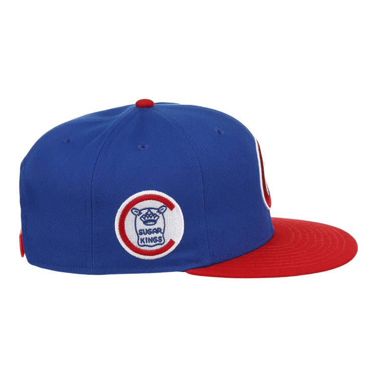 The Havana Sugar Kings EFF MiLB Vintage Snapback by Ebbets Field Flannels features a blue crown, red brim, and side circular logo with Sugar Kings text plus a sugar cane bat and baseball—an iconic piece from the Vintage Minor League collection.