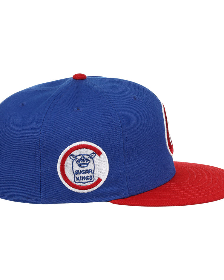 The Havana Sugar Kings EFF MiLB Vintage Snapback by Ebbets Field Flannels features a blue crown, red brim, and side circular logo with Sugar Kings text plus a sugar cane bat and baseball—an iconic piece from the Vintage Minor League collection.