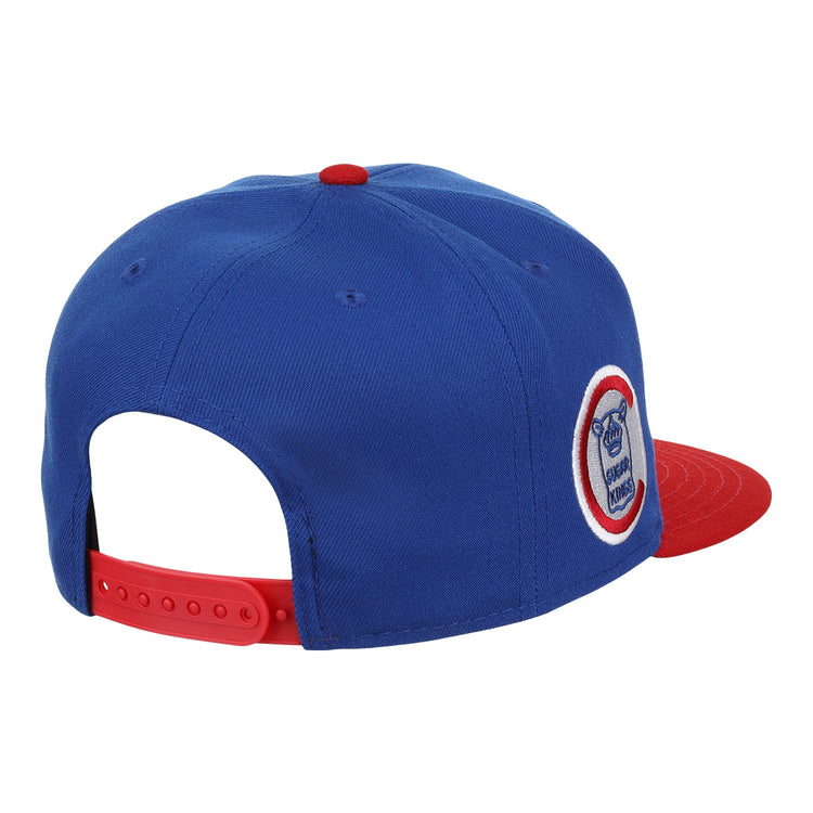 The Havana Sugar Kings EFF MiLB Vintage Snapback by Ebbets Field Flannels is a blue cap with a red brim and adjustable snapback. Inspired by vintage minor league style, it features a circular team logo patch on the side. Shown from back and side angles.