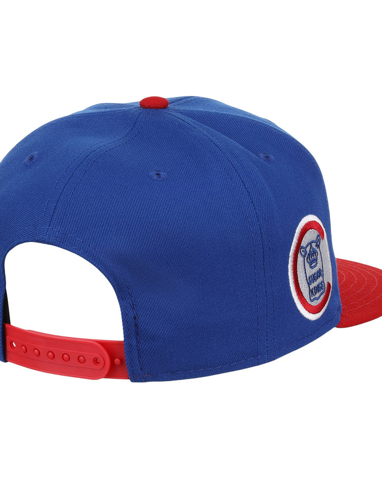 The Havana Sugar Kings EFF MiLB Vintage Snapback by Ebbets Field Flannels is a blue cap with a red brim and adjustable snapback. Inspired by vintage minor league style, it features a circular team logo patch on the side. Shown from back and side angles.