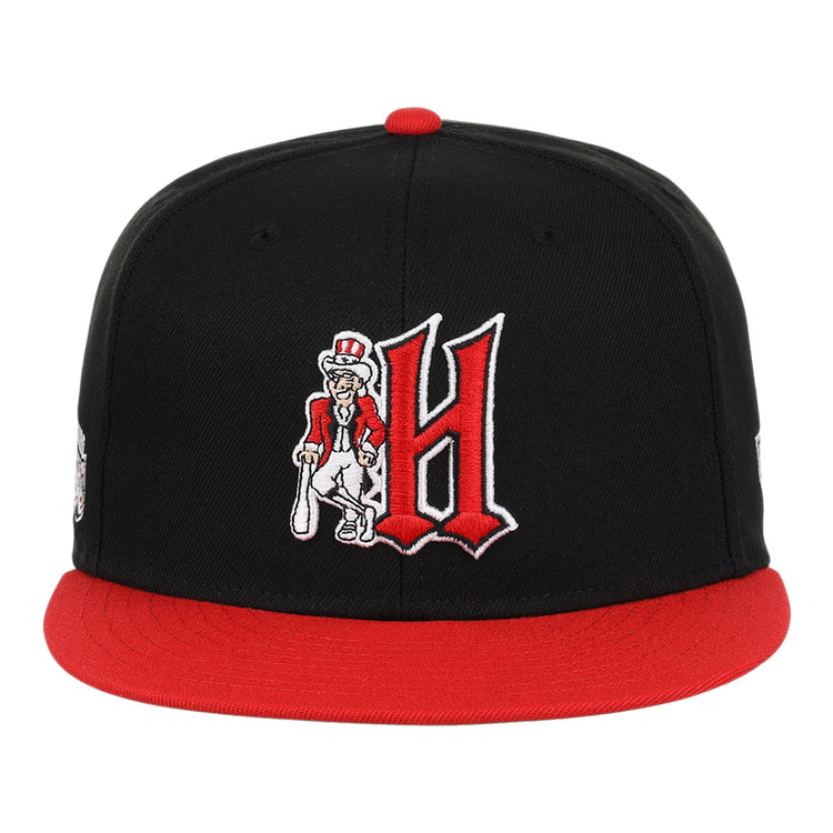 The Ebbets Field Flannels Harrisburg Senators EFF MiLB Vintage Snapback features a black and red adjustable design with a large red H and a cartoon character holding a bat embroidered on the front—ideal for vintage baseball fans.