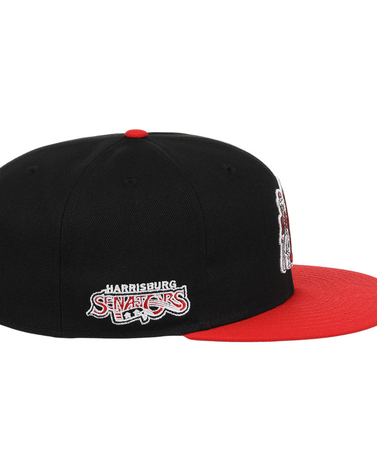 The Harrisburg Senators EFF MiLB Vintage Snapback by Ebbets Field Flannels is a black adjustable cap with a red brim and side-embroidered team logo—ideal for fans of vintage Minor League style.