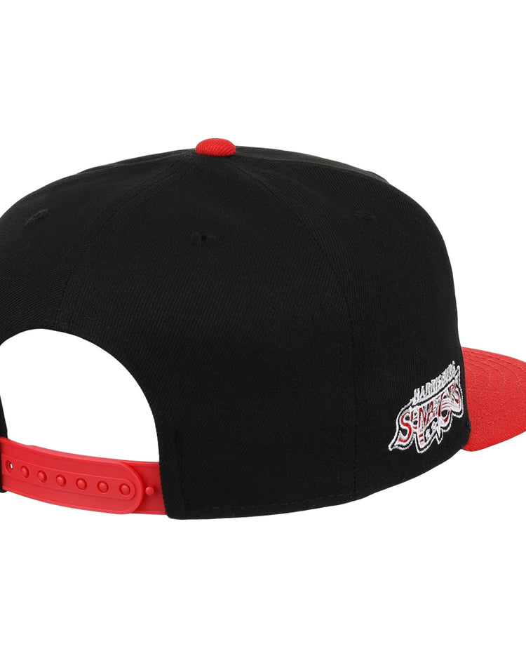 The Harrisburg Senators EFF MiLB Vintage Snapback by Ebbets Field Flannels is a black cap with a red brim and strap, featuring an embroidered Harlem Shake logo in white and red on the back, inspired by vintage Minor League style.