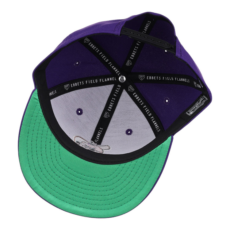 The El Paso Diablos EFF MiLB Vintage Snapback by Ebbets Field Flannels features a purple design, green underbill, black sweatband with EBBETS FIELD FLANNELS text, and adjustable strap—ideal for fans of vintage Minor League style.