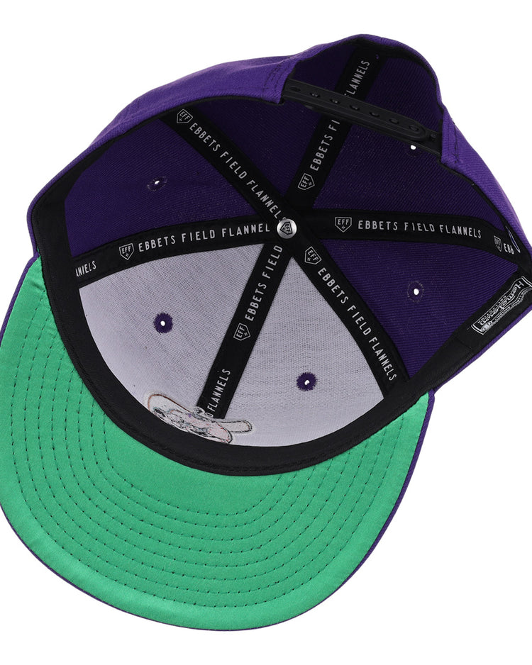 The El Paso Diablos EFF MiLB Vintage Snapback by Ebbets Field Flannels features a purple design, green underbill, black sweatband with EBBETS FIELD FLANNELS text, and adjustable strap—ideal for fans of vintage Minor League style.
