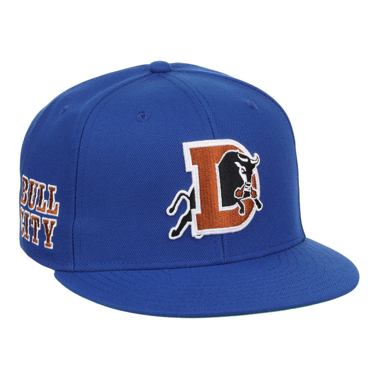 The Durham Bulls EFF MiLB Vintage Snapback by Ebbets Field Flannels features a large “D” with charging bull logo and BULL CITY embroidered on the side, capturing a vintage Minor League style inspired by the Durham Bulls.