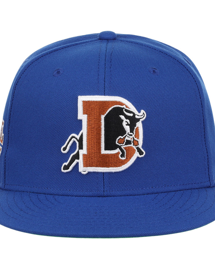The Durham Bulls EFF MiLB Vintage Snapback by Ebbets Field Flannels is a blue adjustable cap featuring a large embroidered D with a charging black bull, inspired by the vintage Minor League style.