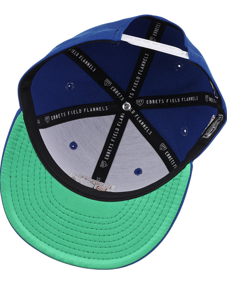 A look inside the Durham Bulls EFF MiLB Vintage Snapback by Ebbets Field Flannels, featuring blue panels, a green undervisor, black Ebbets Field Flannels inner bands, and ventilation holes—a true vintage classic.