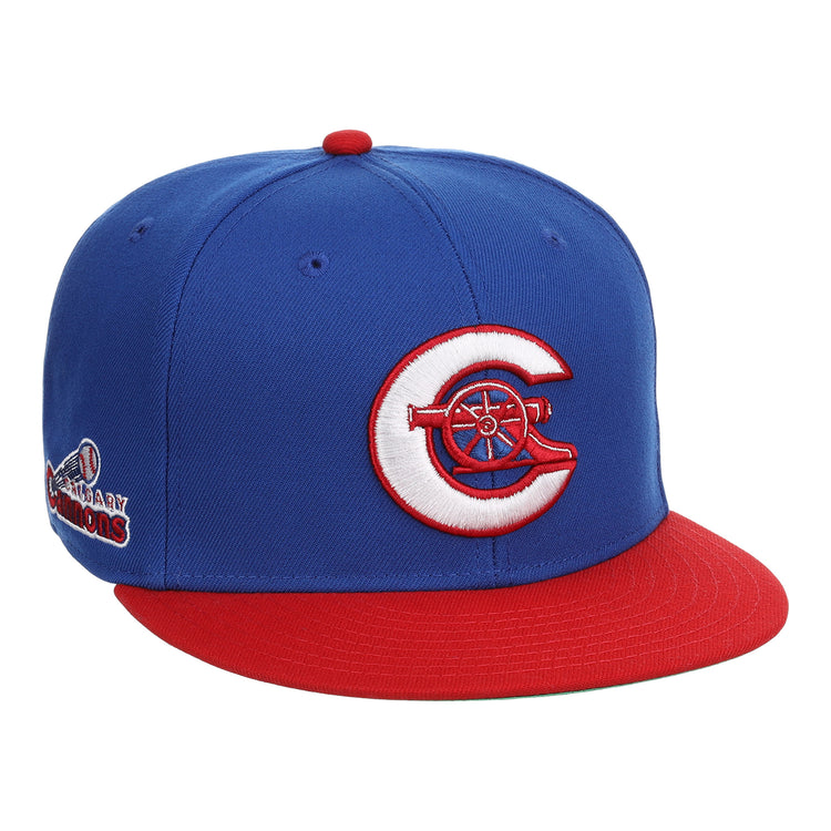 The Calgary Cannons EFF MiLB Vintage Snapback by Ebbets Field Flannels is a blue cap with a red brim, featuring a white and red C logo with a cannon on the front and an embroidered Legendary Cannons patch on the side.