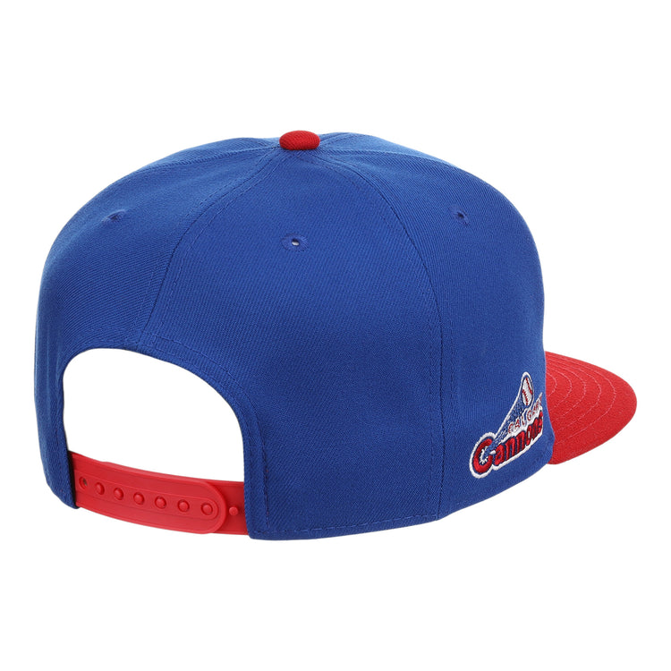 The Ebbets Field Flannels Calgary Cannons EFF MiLB Vintage Snapback is a blue cap with a red brim and button, an embroidered Pacific Coast League logo on the side, and an adjustable red strap for classic minor league style.
