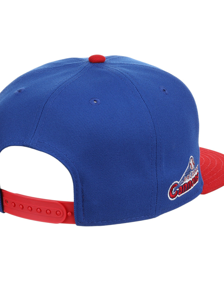 The Ebbets Field Flannels Calgary Cannons EFF MiLB Vintage Snapback is a blue cap with a red brim and button, an embroidered Pacific Coast League logo on the side, and an adjustable red strap for classic minor league style.