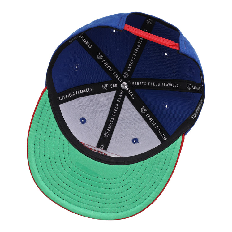 The Calgary Cannons EFF MiLB Vintage Snapback by Ebbets Field Flannels features a green underbrim, black lining with “EBBETS FIELD FLANNELS” text, blue panels, and white stitched ventilation holes—classic Pacific Coast League style.