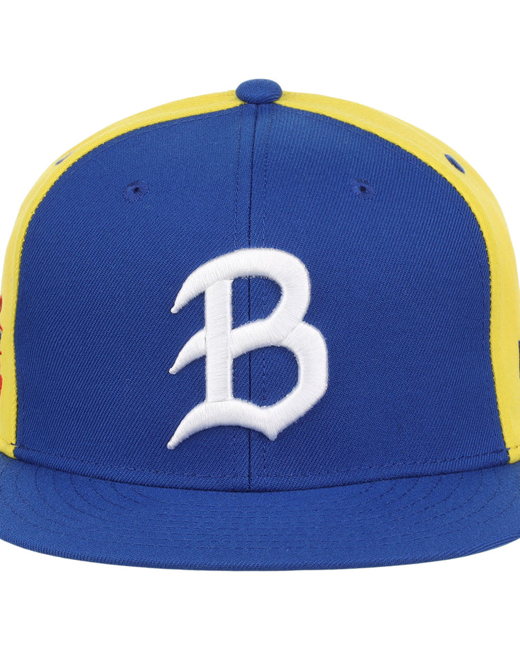 The Burlington Bees EFF MiLB Vintage Snapback by Ebbets Field Flannels features a blue bill and front panel, yellow side panels, a white B embroidered on the front, and a snapback closure for an adjustable fit.