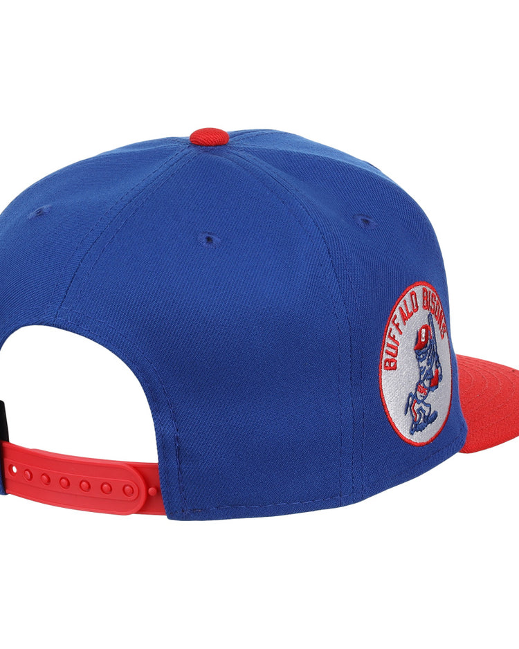 The Buffalo Bisons EFF MiLB Vintage Snapback by Ebbets Field Flannels features a blue crown, red brim and button, bison logo side patch, and a red adjustable strap. Part of the Vintage Minor League collection.