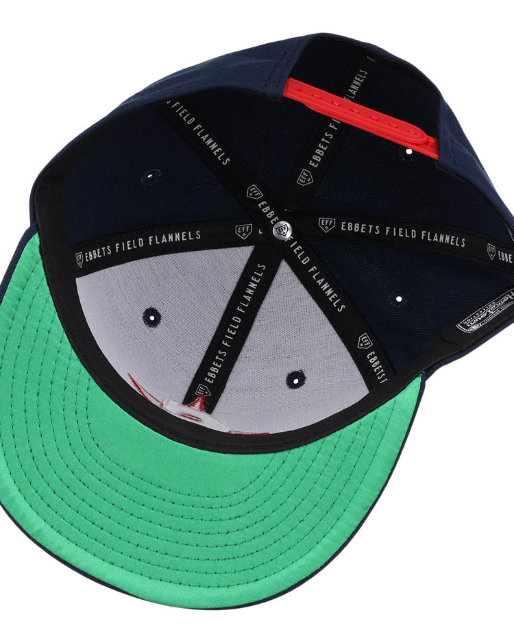 The San Bernardino Spirit EFF MiLB Vintage Snapback by Ebbets Field Flannels features a navy interior, green underbrim, black sweatband, and “EBBETS FIELD FLANNELS” labels—capturing true vintage Minor League style.